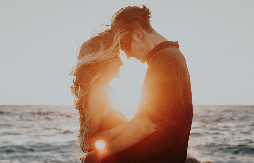 Couple Hugging by the Beach at Sunset